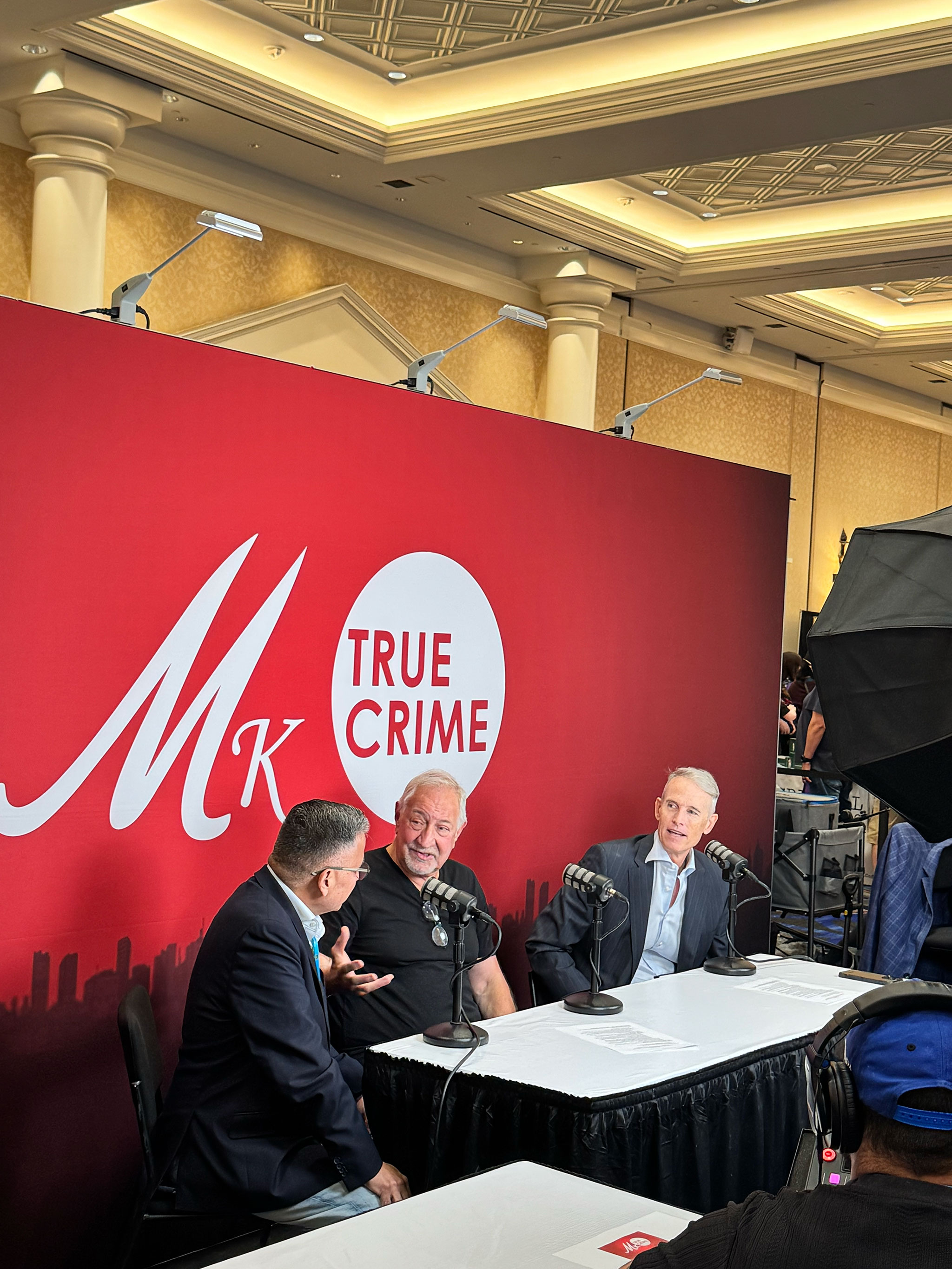 Moses Castillo speaking with fellow attendees and speakers on the CRIMECON exhibition floor