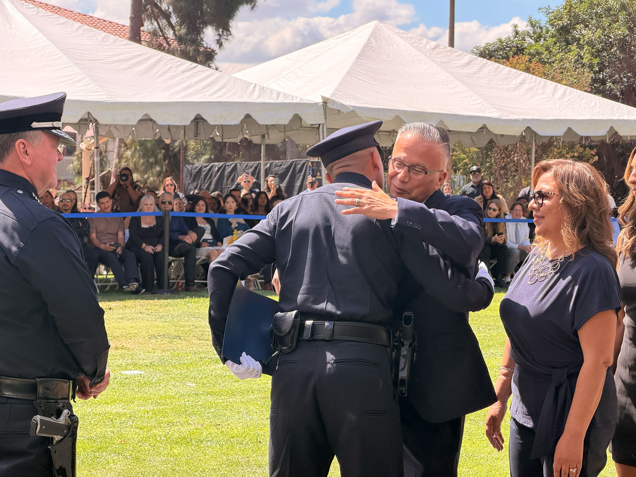 Moses Castillo embracing his son, Officer Christopher Moses Castillo, at the LAPD Elysian Park Academy graduation
